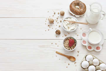 Fototapeta na wymiar Ricotta, granola, fresh bread and egg - homemade healthy breakfast. Top view on a white wooden background.