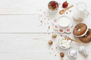 Obraz na płótnie Canvas Ricotta, granola, fresh bread and egg - homemade healthy breakfast. Top view on a white wooden background.