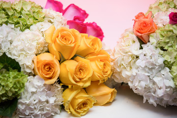 Beautiful colorful roses on table. Concept happy valentines day. Flower bouquet on a romantic celebration. Roses and Hortensias closeup.