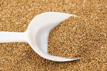 spoon with buckwheat on the background of buckwheat