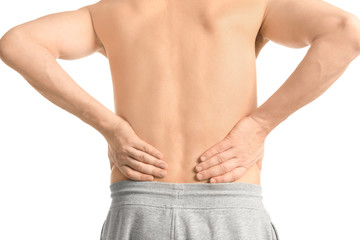 Fototapeta premium Young man suffering from back pain on white background