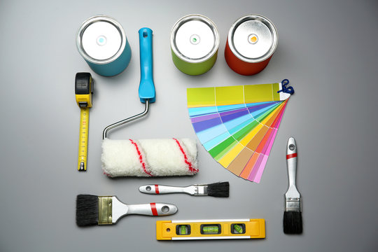 Set of decorator's tools on grey background