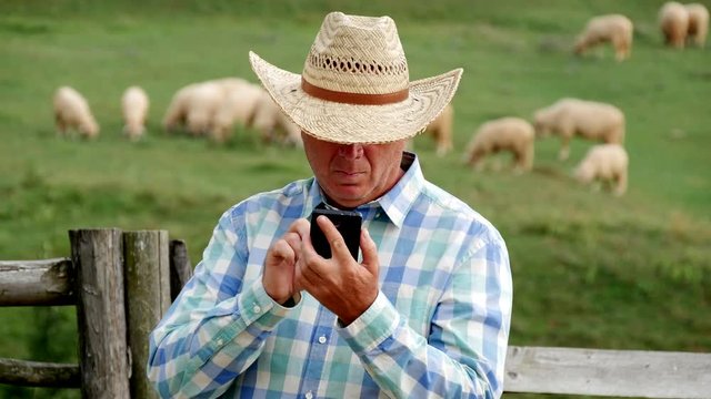Busy Farmer Use Mobile to Send and Receive Messages