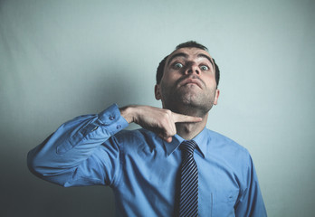 Caucasian businessman showing I will cut you head.