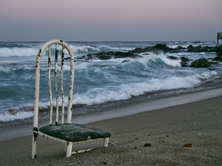 Old chair on a deserted beach. Sokcho city. South Korea