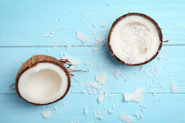 Composition with fresh coconut flakes on color wooden background, top view