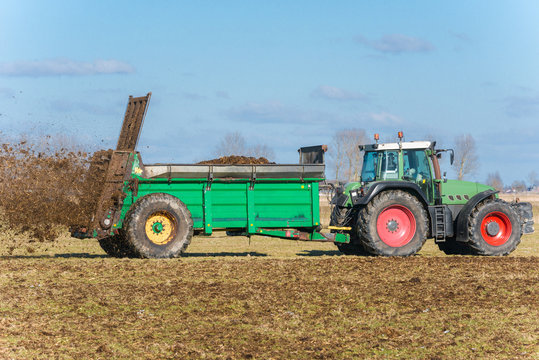 Tractor with manure spreader on the field - 1298