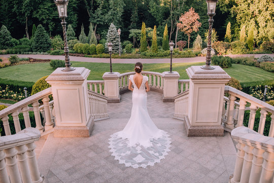 bride chic dress architecture lanterns beautiful garden - Powered by Adobe