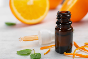 Bottle with essential oil on table, closeup