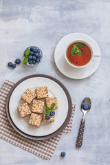 Homemade sweets or candies Pigeon's milk with a cup of tea, blueberries and mint