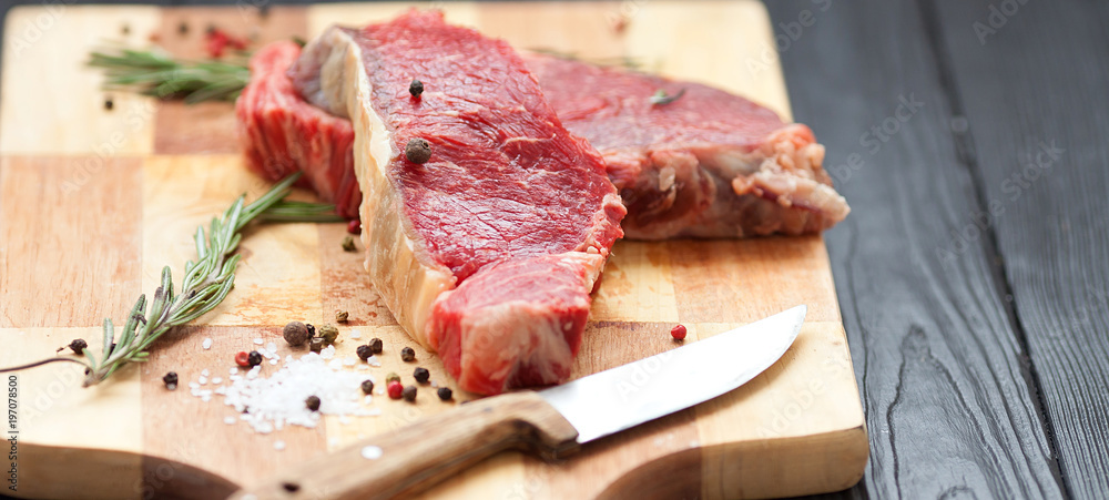 Wall mural raw steak on cutting board