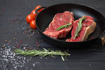 raw steak on cast iron frying pan