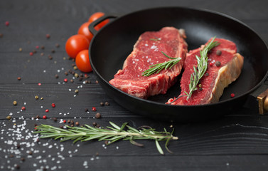 raw steak on cast iron frying pan