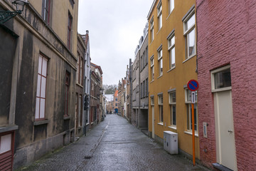 Fototapeta na wymiar Bruges alley view with snow