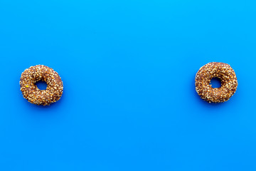 Sweet tasty snack. Glazed donut on blue background top view copy space