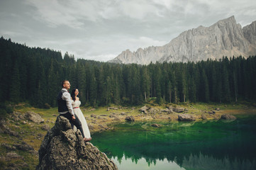 Happy couple of newlyweds against the backdrop of the mountains 