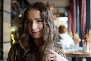 Portrait of a pretty girl with long brown hair