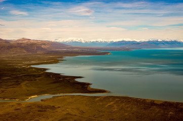 aerial view of El Calafate with its airport at Lago Argentina and the andes in the back, Patagonia, Argentina