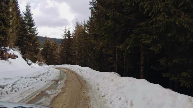 4X4 car on winter mountain road. POV view
