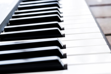 Side view of piano keys. Close-up of piano keys. Close frontal view. Piano keyboard with selective focus. Diagonal view. Piano keyboard perspective