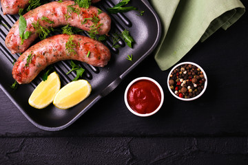 Grilled sausages with lime on iron grill pan