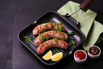 Grilled sausages with lime on iron grill pan