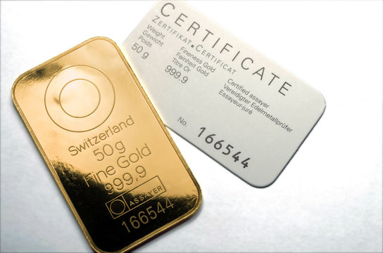 Minted gold bar weighing 50 grams with certificate. Gold ingot with assay certificate.