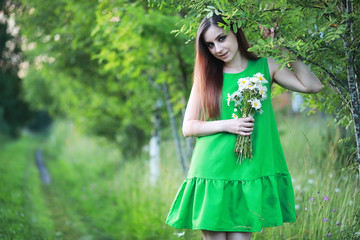 beautiful girl with red hair with a bouquet