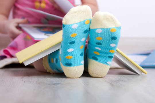 child's feet reading books