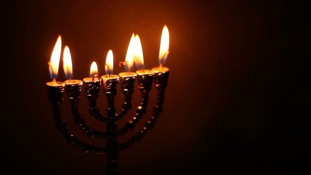 Flame of menorah on the dark background