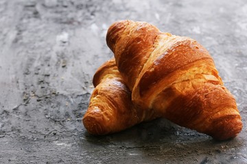 Homemade Butter Croissants on dark moody background, selective focus