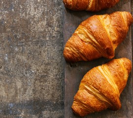 Homemade Butter Croissants on dark moody background, selective focus
