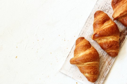 Fresh Baked Butter Croissants On White Background, Overhead View