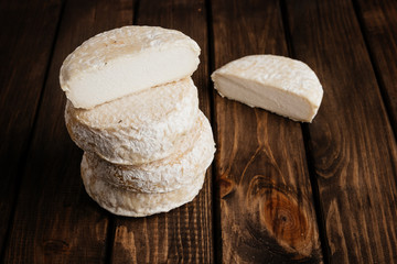 Top View of Crafted Camembert on Wooden Background with Free Space for Text at the Right Side of the Photo.