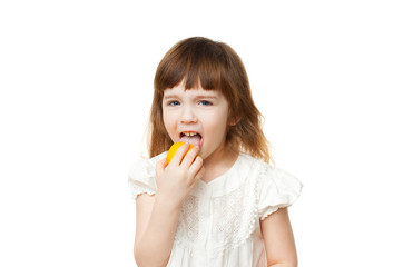 Girl 4-5 years crooked and eating lemon on white background