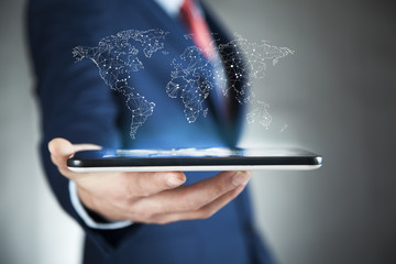 Businessman holding digital tactile world over mobiel phone