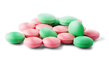Obraz na płótnie Canvas Heap of medical pills in green and pink colors on isolated white background. Concept of healthcare and medicine.