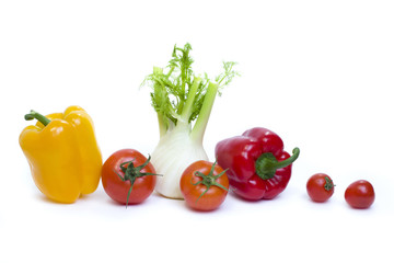 Root of parsley of red pepper with yellow pepper and tomatoes on white background.