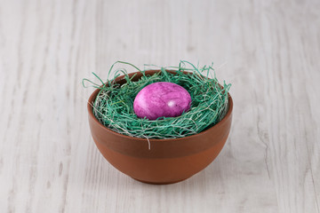 easter eggs in bowl on a wooden background