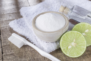 baking soda and lemon on wooden table