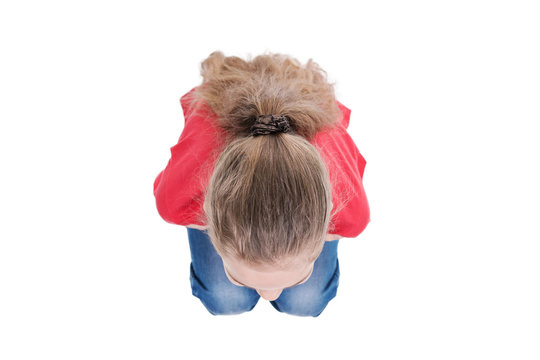 Girl in red clothes squatting, top view, isolated on white background