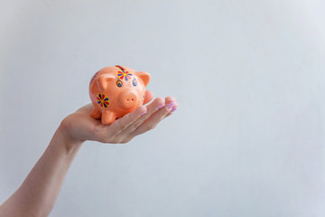 Woman hand hold pink piggy bank. Saving investment budget wealth business retirement concept