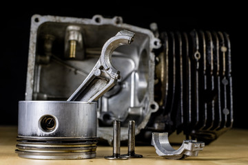 Crankshaft, piston and other parts of the internal combustion engine. Disassembled single-piston four-stroke engine on the workbench.