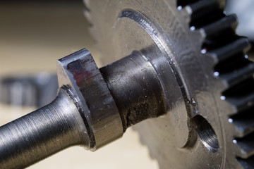 Crankshaft, piston and other parts of the internal combustion engine. Disassembled single-piston four-stroke engine on the workbench.