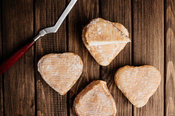 Top View of Delicious Cheese on Wooden Brown Background with Knife for Slicing.