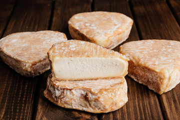 Top View of Delicious Cheese on Wooden Brown Background.