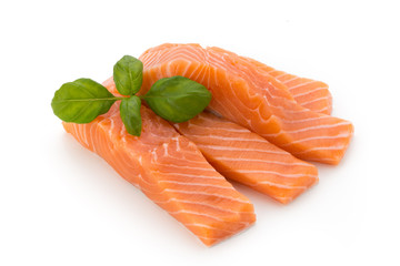 Fresh salmon fillet with basil on the white background.