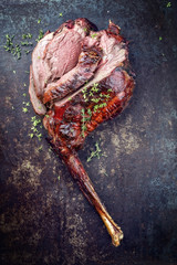 Marinated sliced barbecue aged leg of venison as top view on rustic background