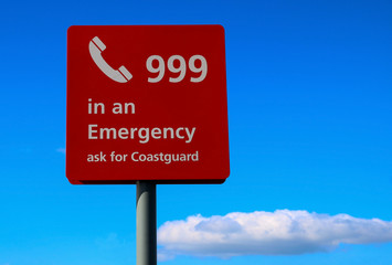 Emergency Sign at a Coastal Beach