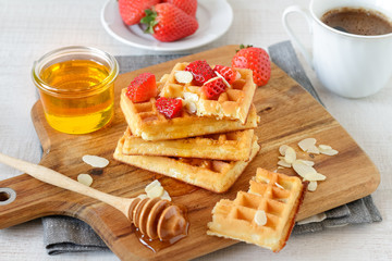 Healthy breakfast table with belgian waffles, fruits and coffee